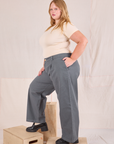 Side view of Mid-Rise Pleated Trousers in Slate Grey and Baby Tee in vintage tee off-white on Juliet