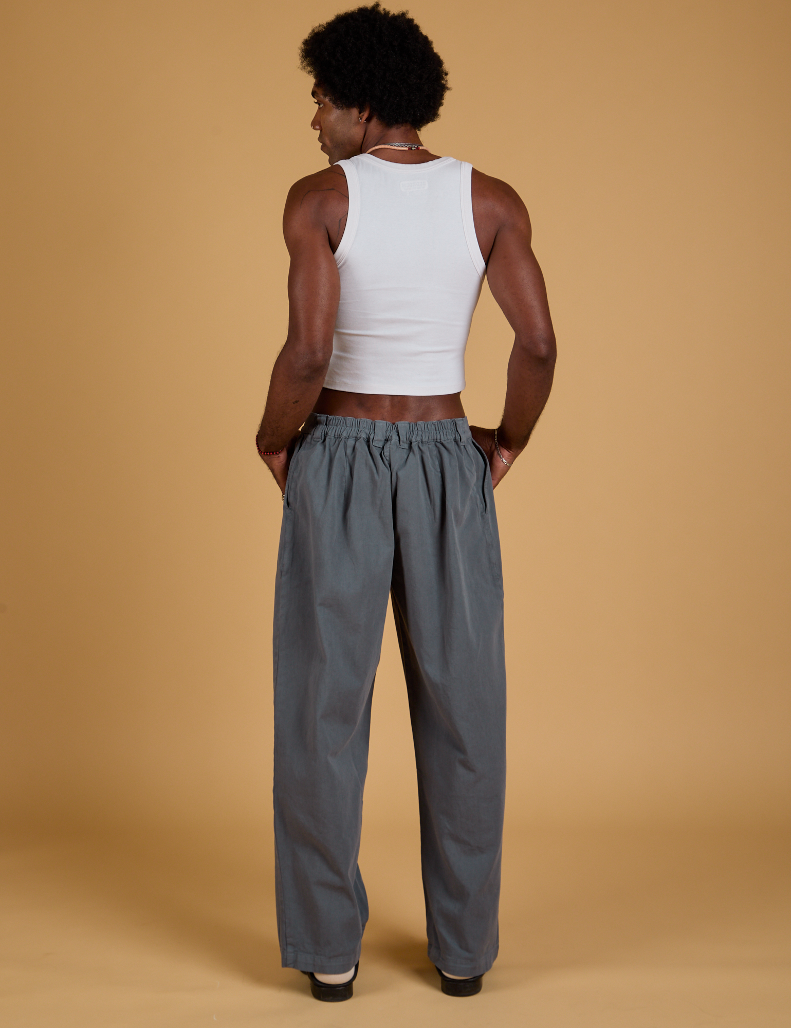 Back view of Baggy Mid-Rise Trousers in Slate Grey and vintage tee white on Jerrod