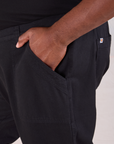 Mid-Rise Work Pants in Basic Black close up of Elijah's hand in the front pocket