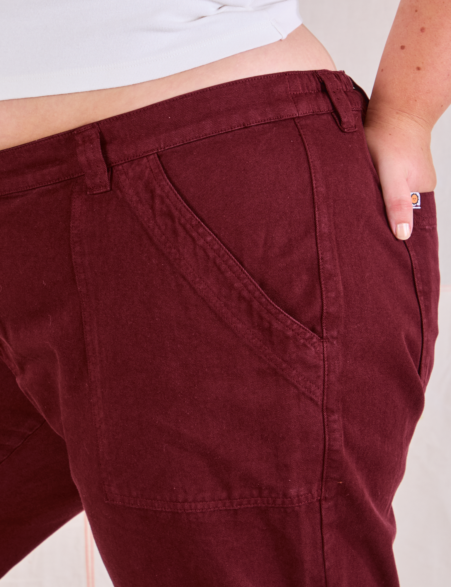 Mid-Rise Work Pants in Red Wine front pocket close up on Juliet