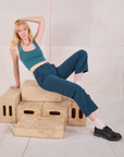 Margaret is wearing Mid-Rise Work Pants in Lagoon and marine blue Cropped Tank