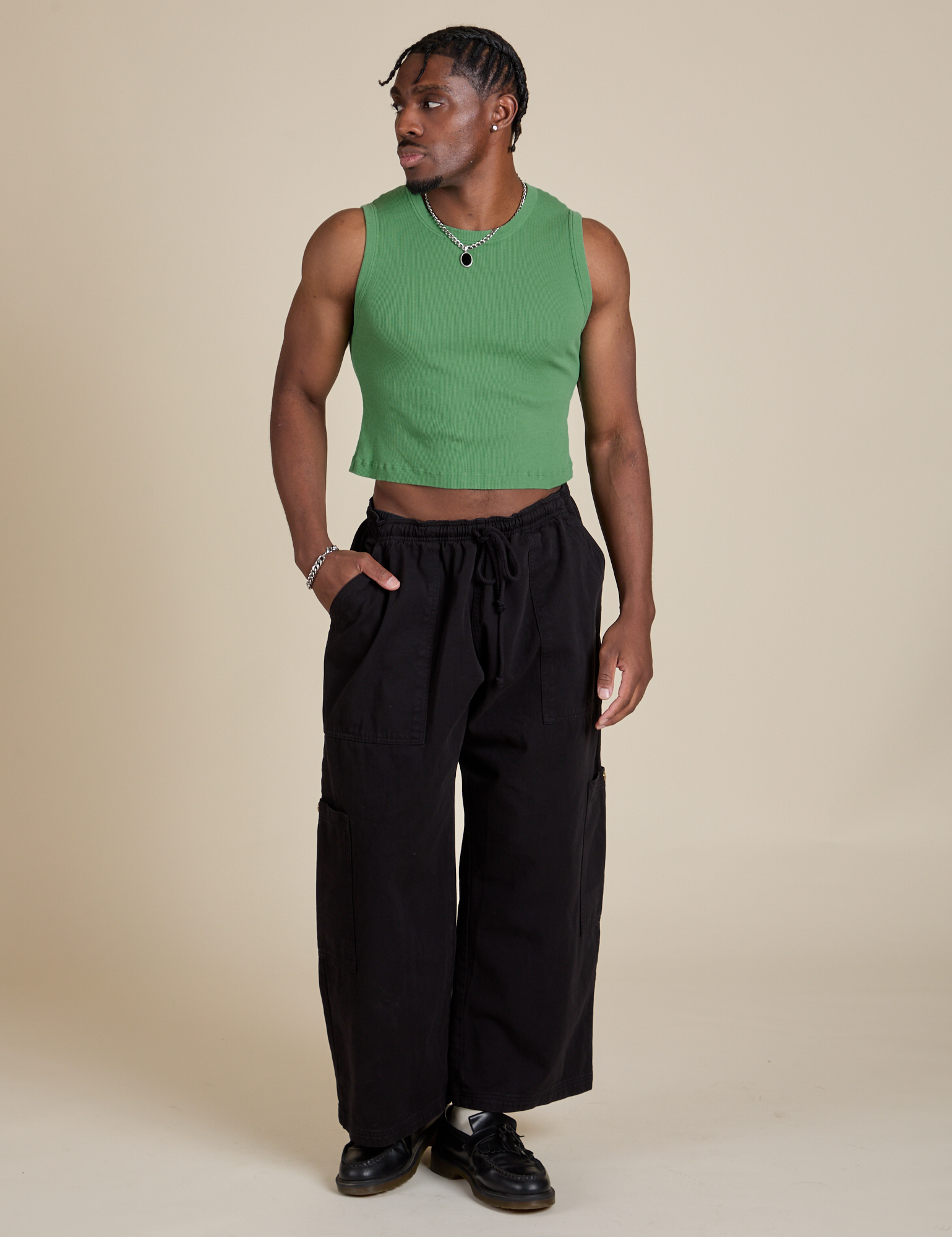 Isaac is wearing Muscle Tee in Seafoam Green paired with black Drop Pocket Cargo Pants