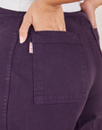 Back pocket close up of Bell Bottoms in Nebula Purple. Tiara has her hand in the pocket.
