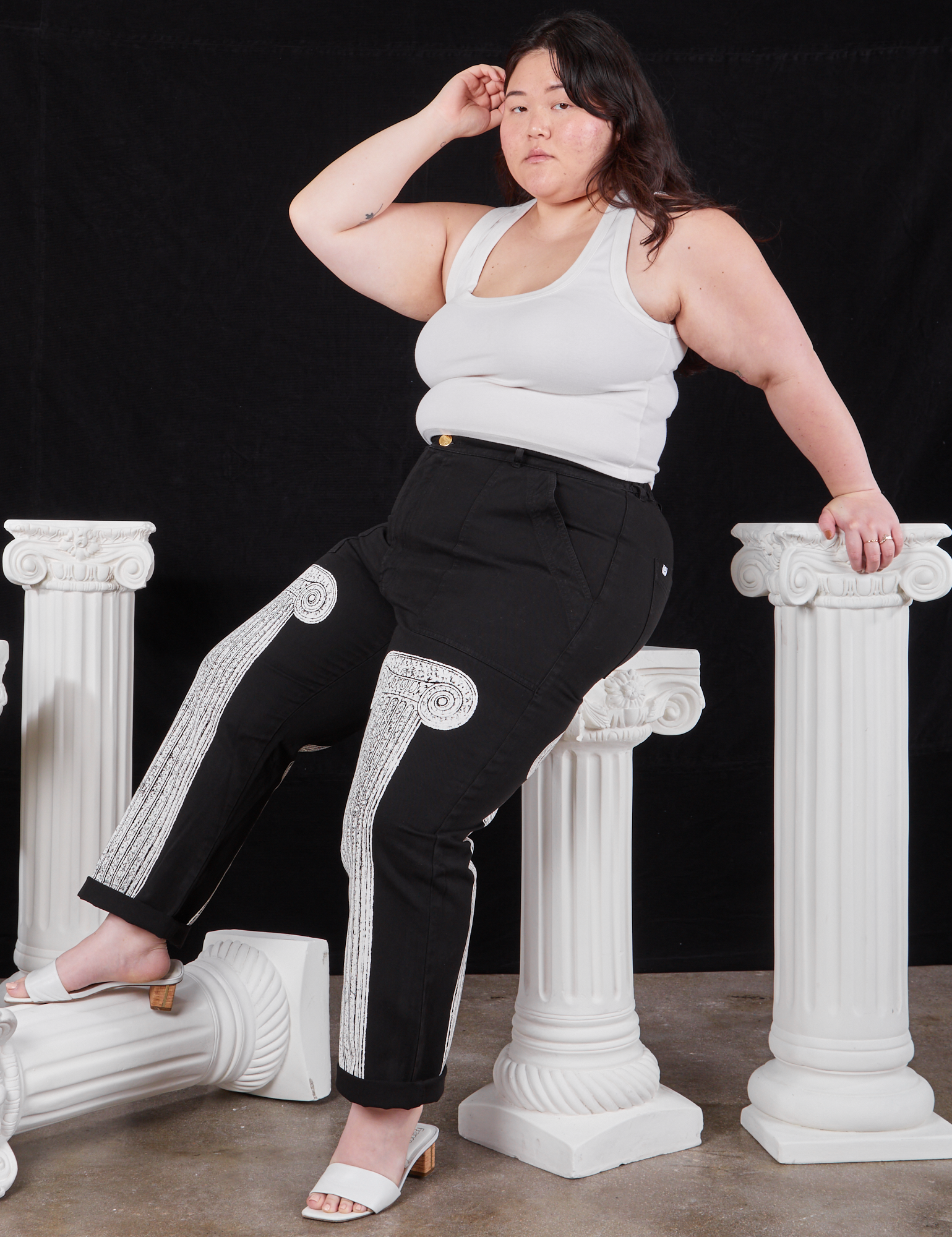 Ashley is wearing Column Work Pants in Basic Black and vintage off-white Cropped Tank Top