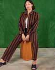 Tiara is wearing Black Stripe Work Pants in Fudgesicle Brown and matching Ricky Jacket