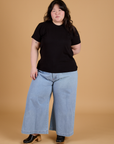 Ashley is wearing Organic Vintage Tee in Basic Black and light wash Indigo Wide Leg Trousers