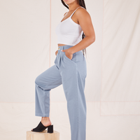 Side view of Organic Trousers in Periwinkle and vintage off-white Cropped Cami worn by Gabi