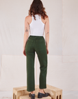 Back view of Organic Work Pants in Swamp Green and Racerback Tank in vintage tee off-white on Alex