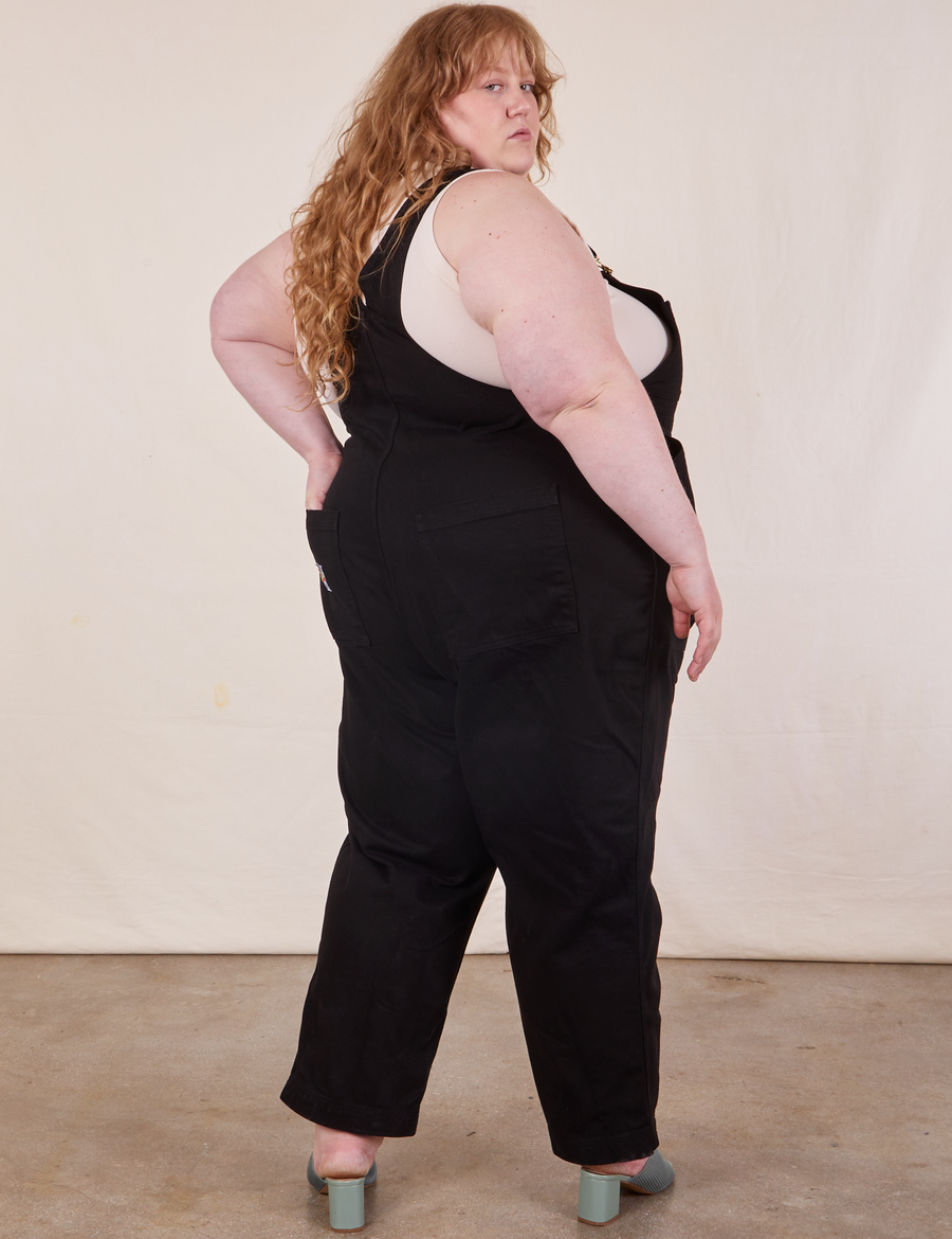 Angled back view of Original Overalls in Mono Black worn by Catie