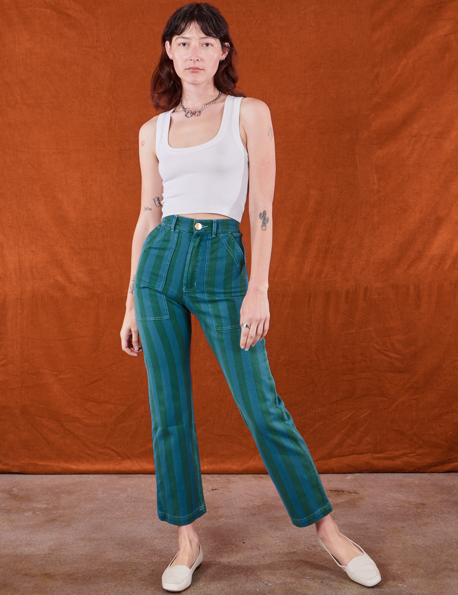 Alex is wearing Overdye Stripe Work Pants in Blue/Green and vintage off-white Cropped Tank Top