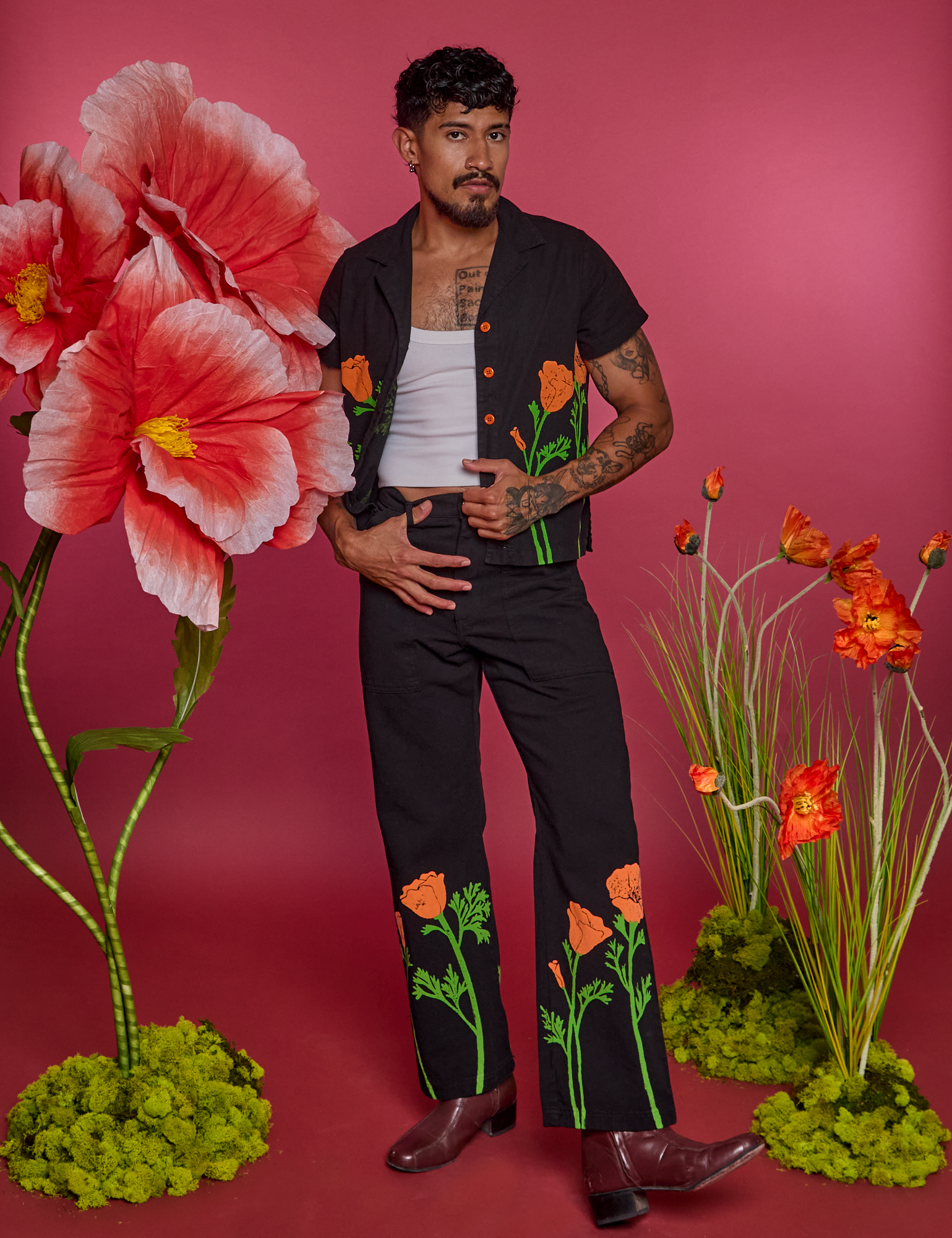 Jesse is wearing Paintstamped Work Pants in Poppy and matching Work Pants