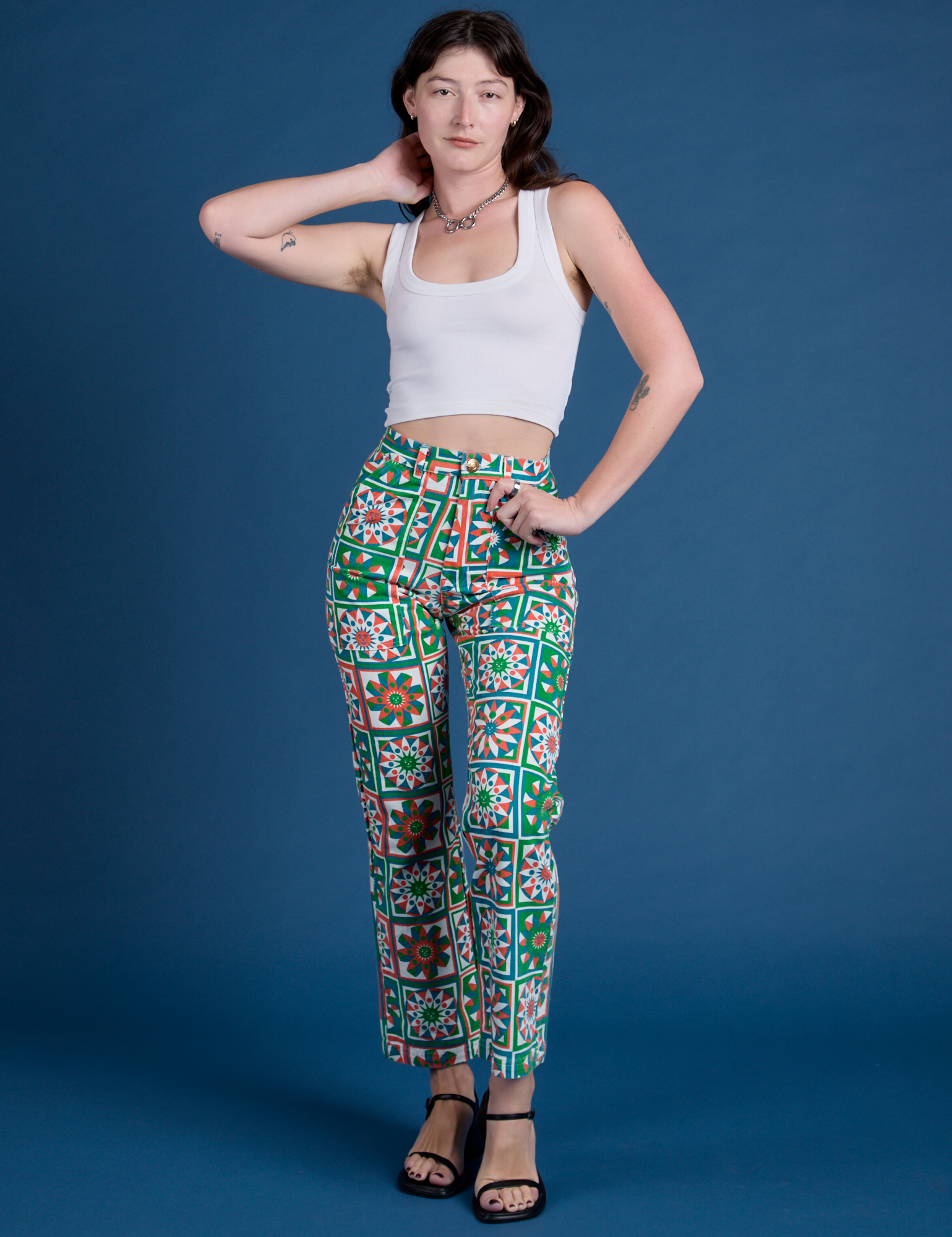 Alex is 5’8” and wearing XXS Work Pants in Quilt Print paired with vintage tee white Cropped Tank
