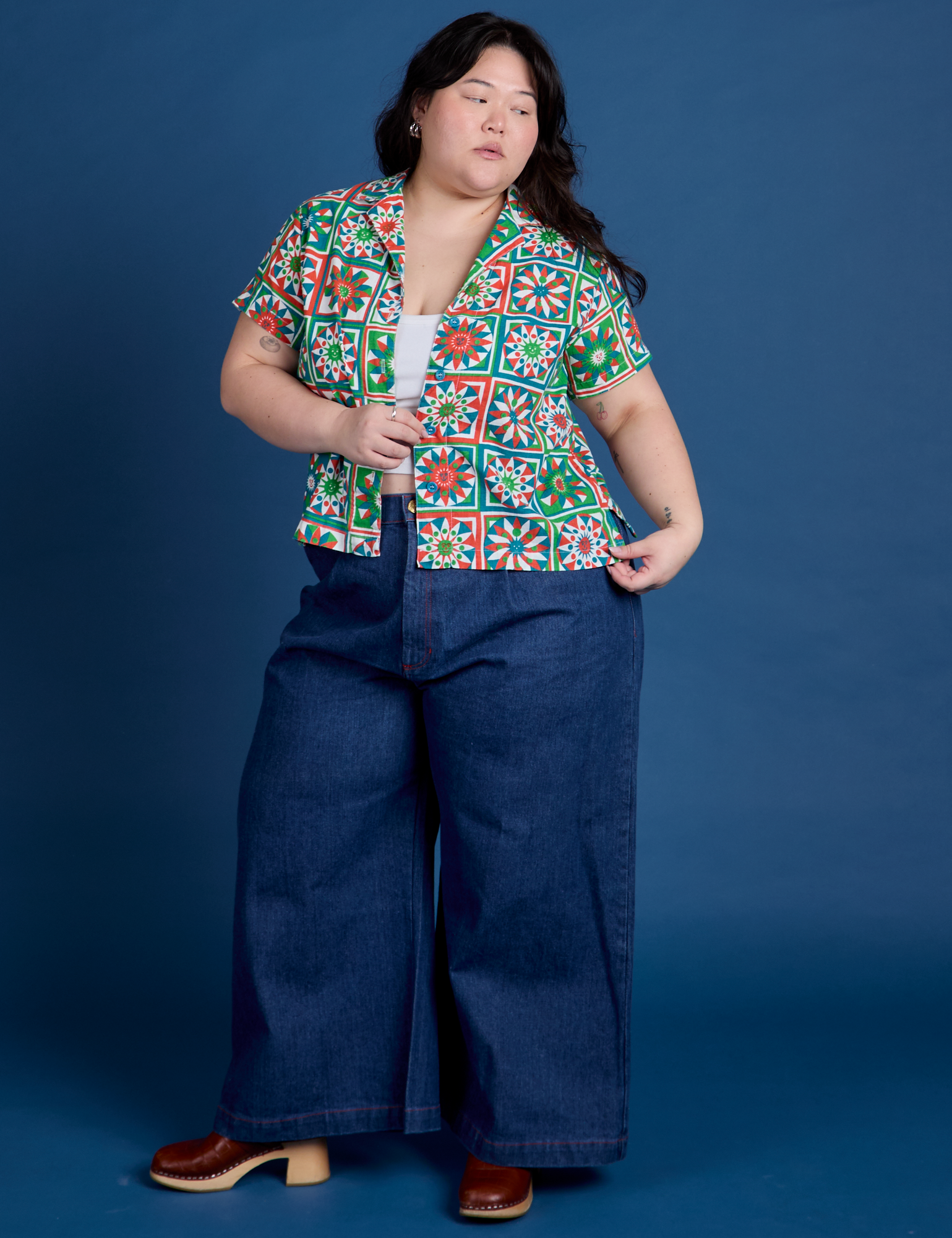 Ashley is wearing Quilt Print Pantry Button-Up and dark wash Indigo Wide Leg Trousers