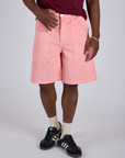 Close up of Longline Work Shorts in Baby Pink on Isaac