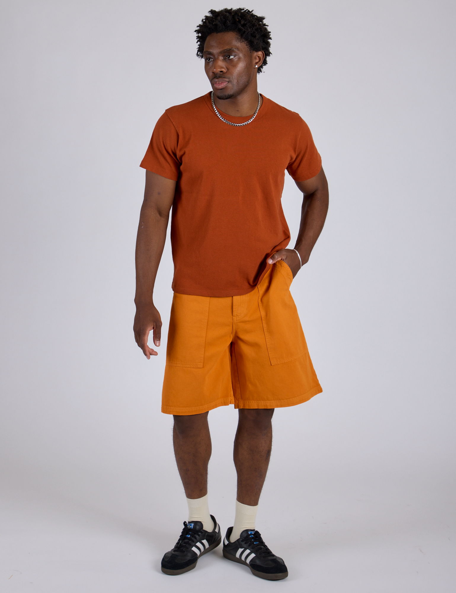 Isaac is 5’10” and wearing M Longline Work Shorts in Creamsicle Orange paired with burnt terracotta Organic Vintage Tee