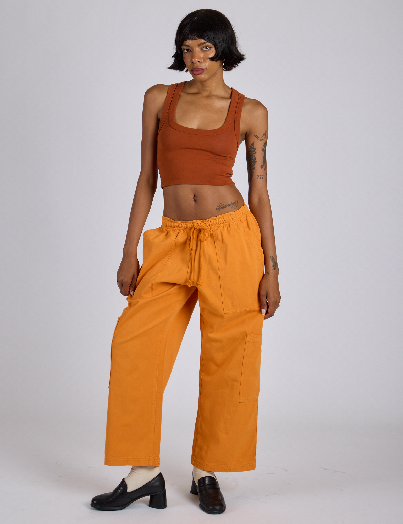 Drop Pocket Cargo Pants in Creamsicle Orange and burnt terracotta Cropped Tank on Kira