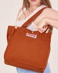 Shopper Tote Bag in Burnt Orange worn as a shoulder bag on Allison