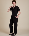 Angled front view of Short Sleeve Jumpsuit in Basic Black on Quinn