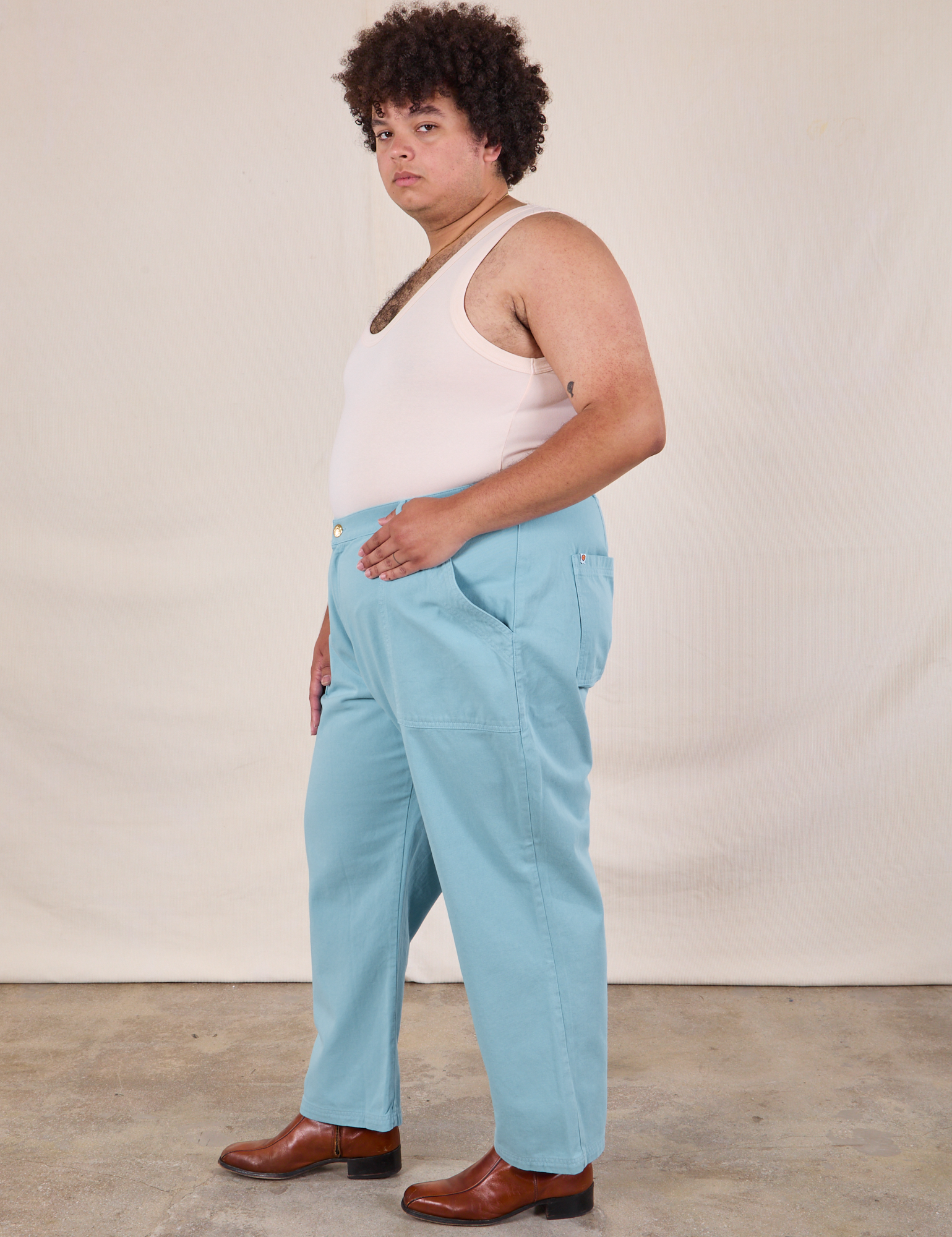 Side view of Work Pants in Baby Blue and Tank Top in vintage tee off-white on Miguel