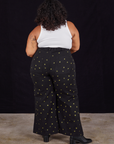 Back view of Star Bell Bottoms in Black and Cropped Tank in vintage tee off-white on Morgan