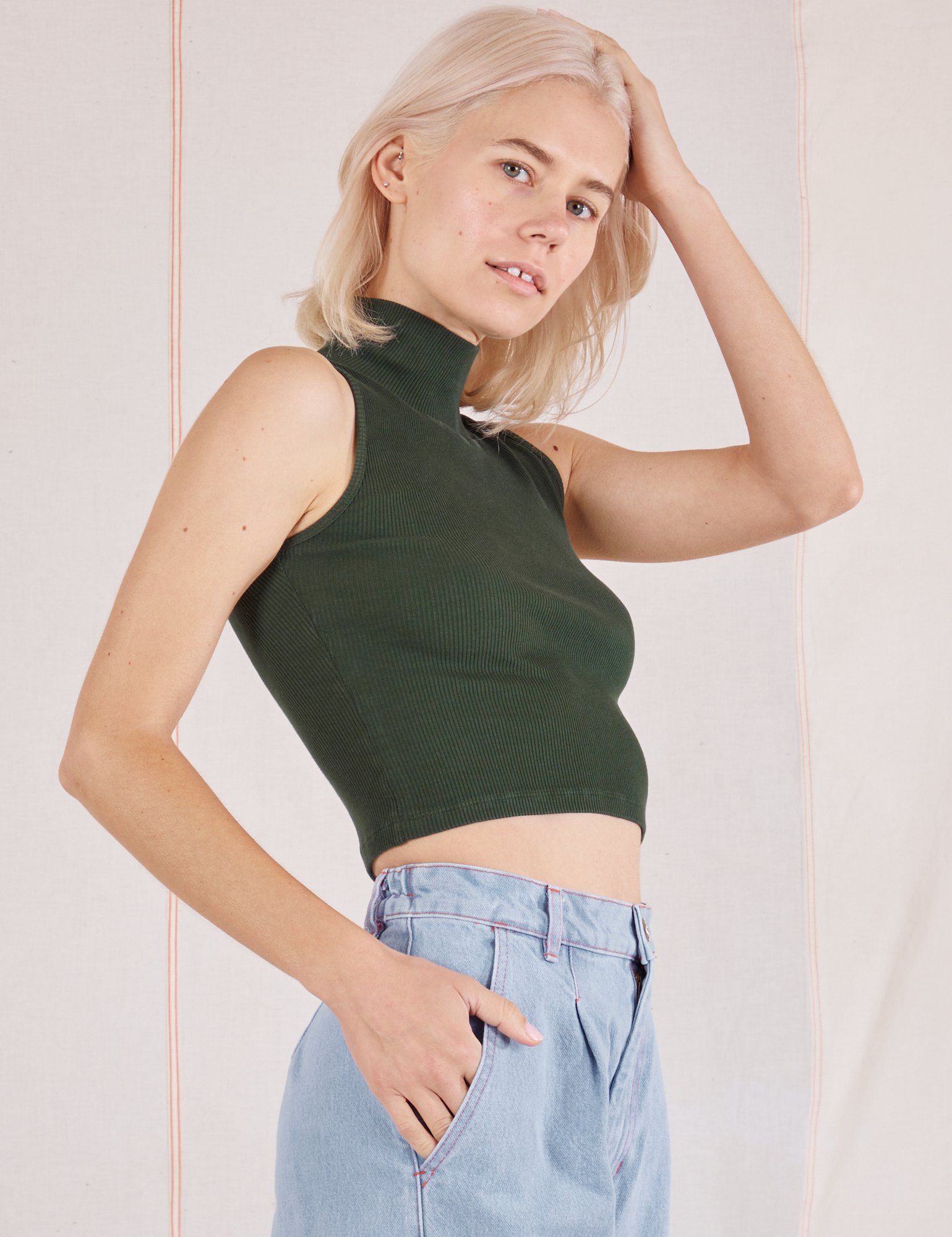 Sleeveless Essential Turtleneck in Swamp Green side view on Madeline