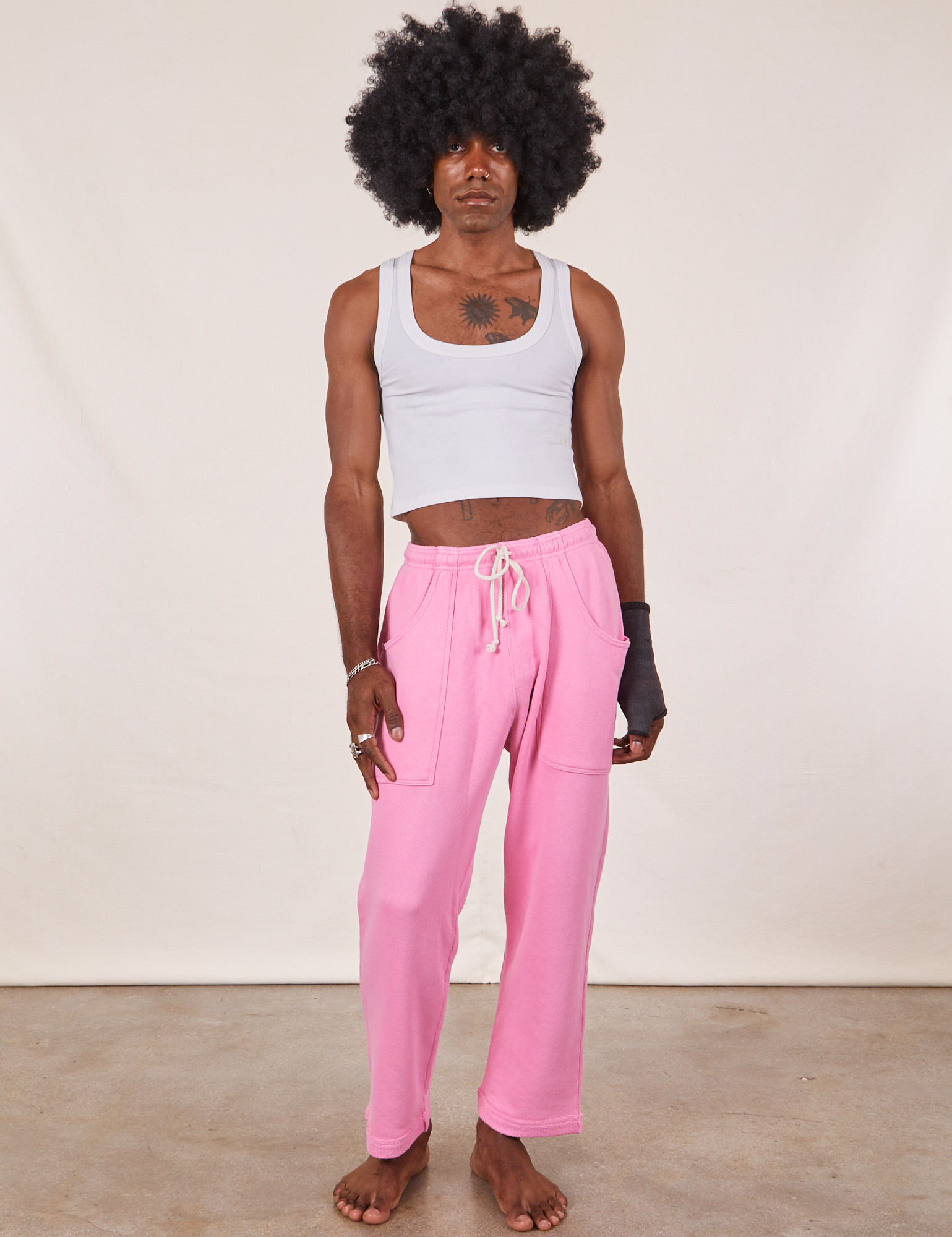 Jerrod is 6&#39;3&quot; and wearing M Cropped Rolled Cuff Sweatpants in Bubblegum Pink paired with vintage off-white Cropped Tank Top