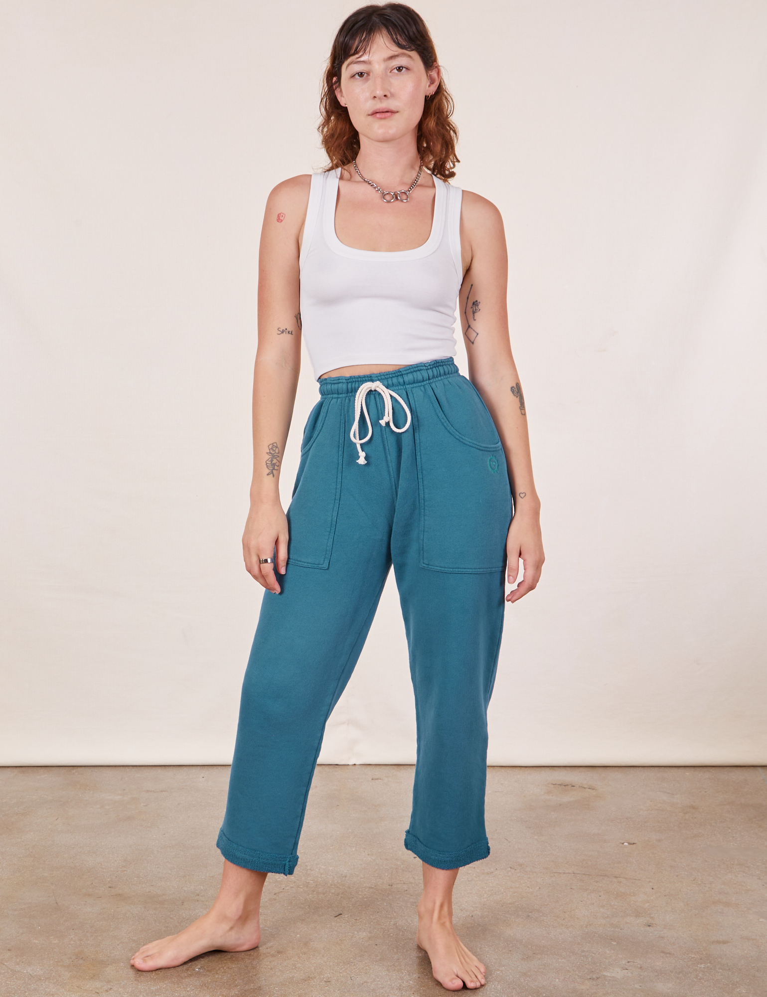 Alex is 5&#39;8&quot; and wearing XXS Cropped Rolled Cuff Sweatpants in Marine Blue