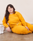 Ashley is wearing Heavyweight Crew in Mustard Yellow and matching Cropped Rolled Cuff Sweatpants