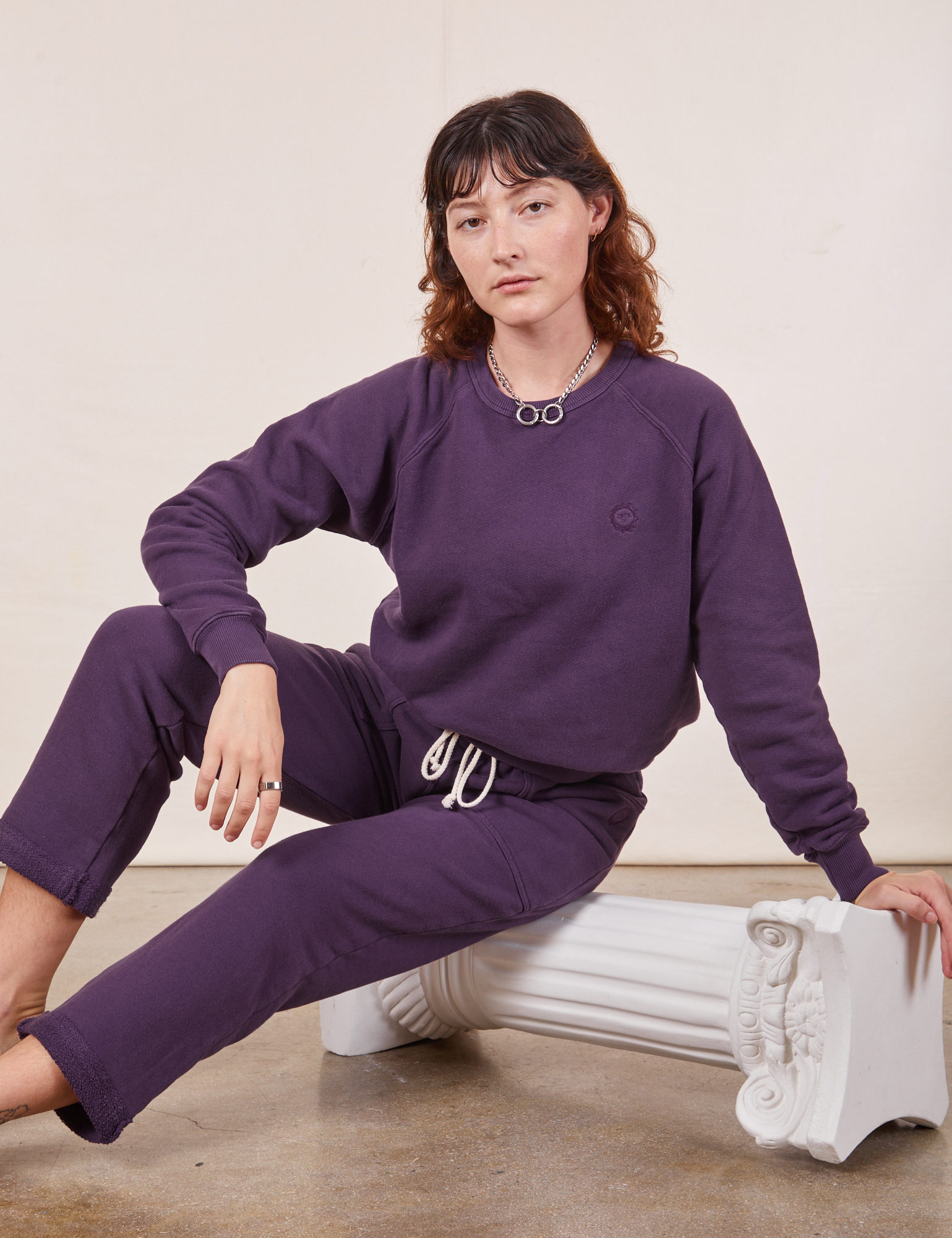 Alex is wearing Heavyweight Crew in Nebula Purple and matching Cropped Rolled Cuff Sweatpants