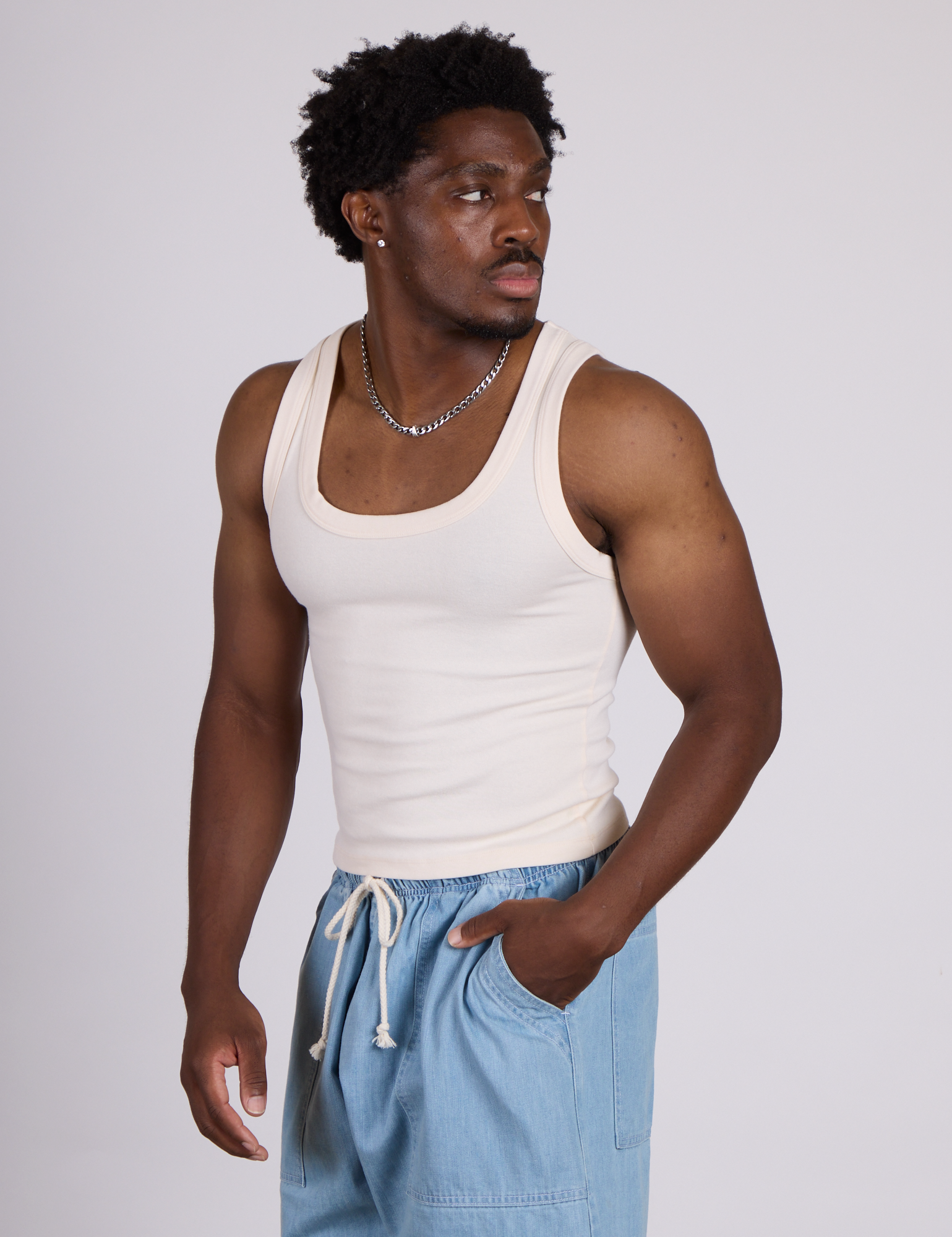 Angled front view of The Tank Top in Vintage Tee Off-White on Isaac