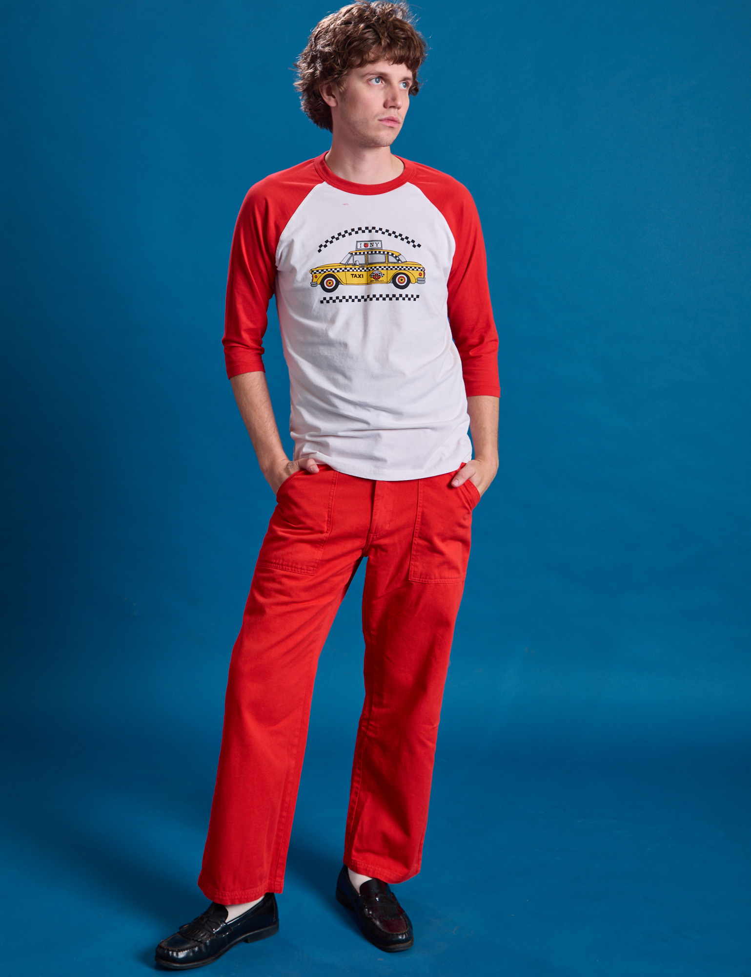Quinn is wearing Taxi Raglan Tee in NYC and mustang red Work Pants