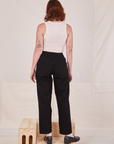 Back view of Denim Trouser Jeans in Black and vintage off-white Tank Top worn by Alex