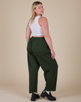 Angled back view of Heavyweight Trousers in Swamp Green and Cropped Tank in Vintage Tee White on Lish
