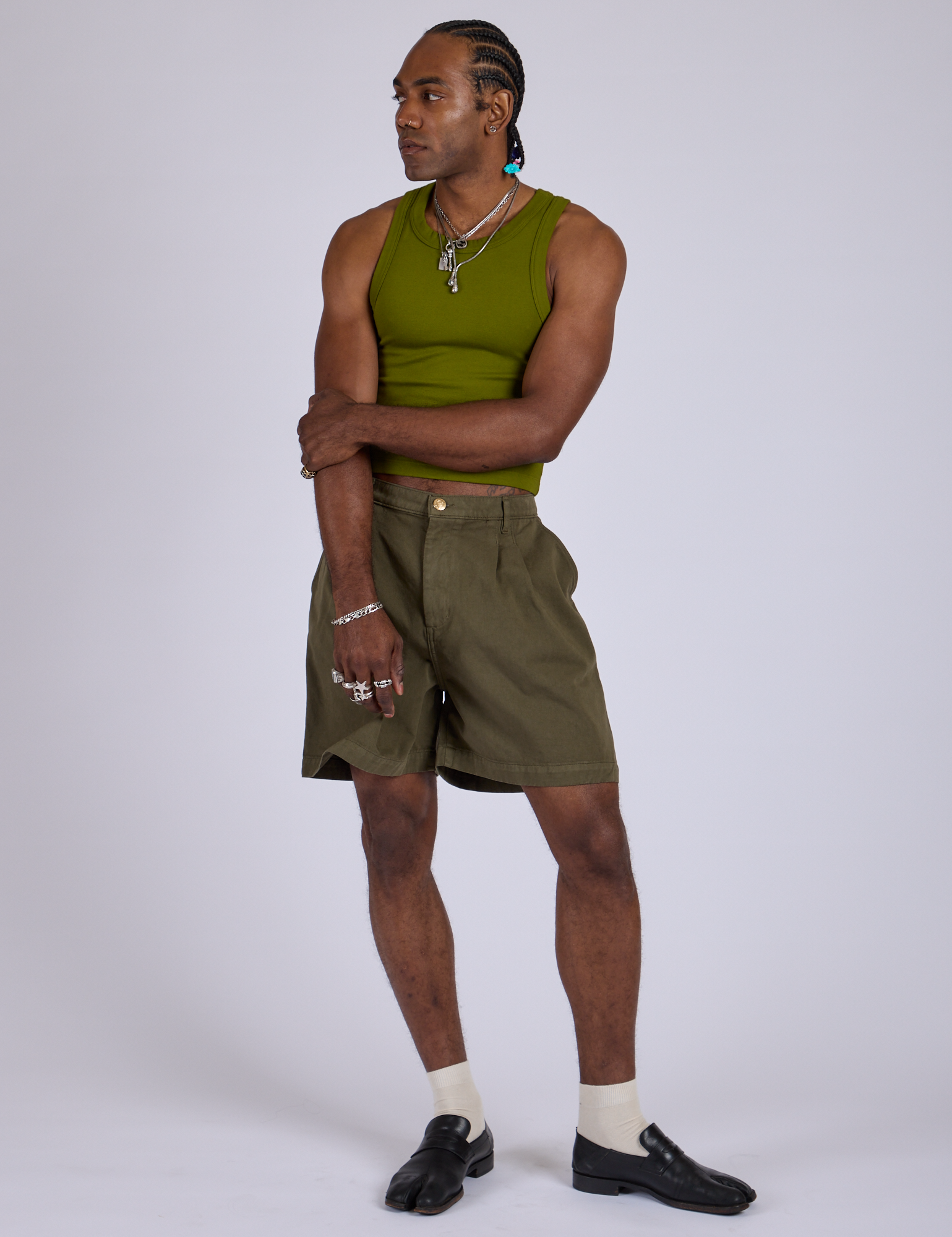 Jerrod is 6’3” and wearing M Pleated Trouser Shorts in Surplus Green paired with summer olive Racerback