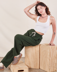 Alex is wearing Wide Leg Sweat Pants in Swamp Green and Cropped Tank in vintage tee off-white