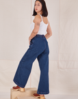 Angled back view of Indigo Wide Leg Trousers in Dark Wash on Betty