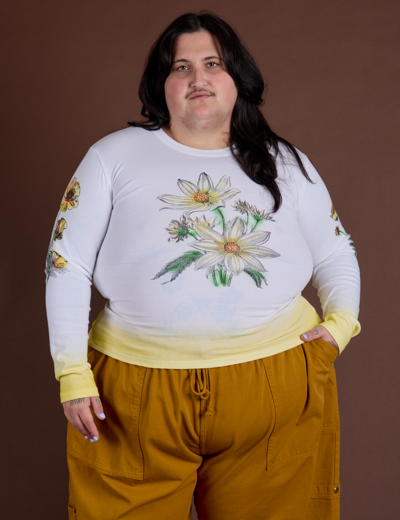 Sam is 5’10” and wearing XL Floral Long Sleeve Baby Tee in Yellow