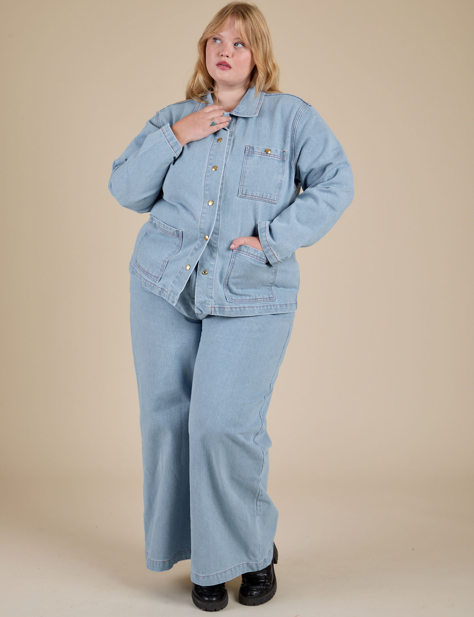 Juliet is wearing Indigo Denim Work Jacket in Light Wash and light wash Indigo Wide Leg Trousers