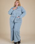 Juliet is wearing Indigo Denim Work Jacket in Light Wash and light wash Indigo Wide Leg Trousers