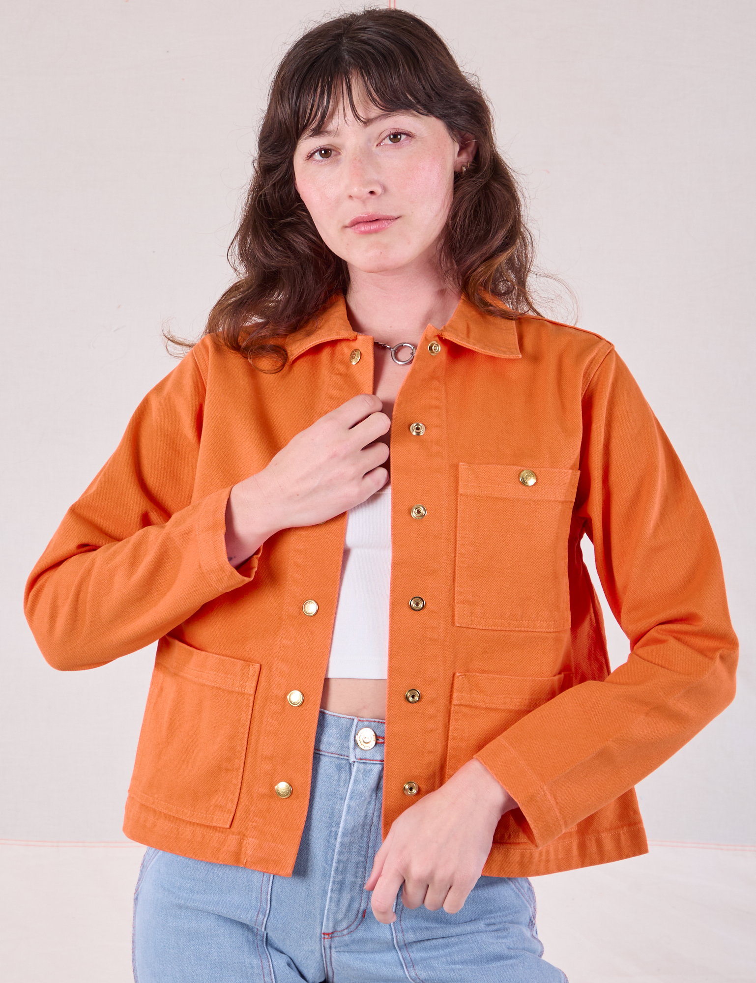 Alex is 5&#39;8&quot; and wearing P Denim Work Jacket in Construction Orange