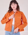 Alex is 5'8" and wearing P Denim Work Jacket in Construction Orange