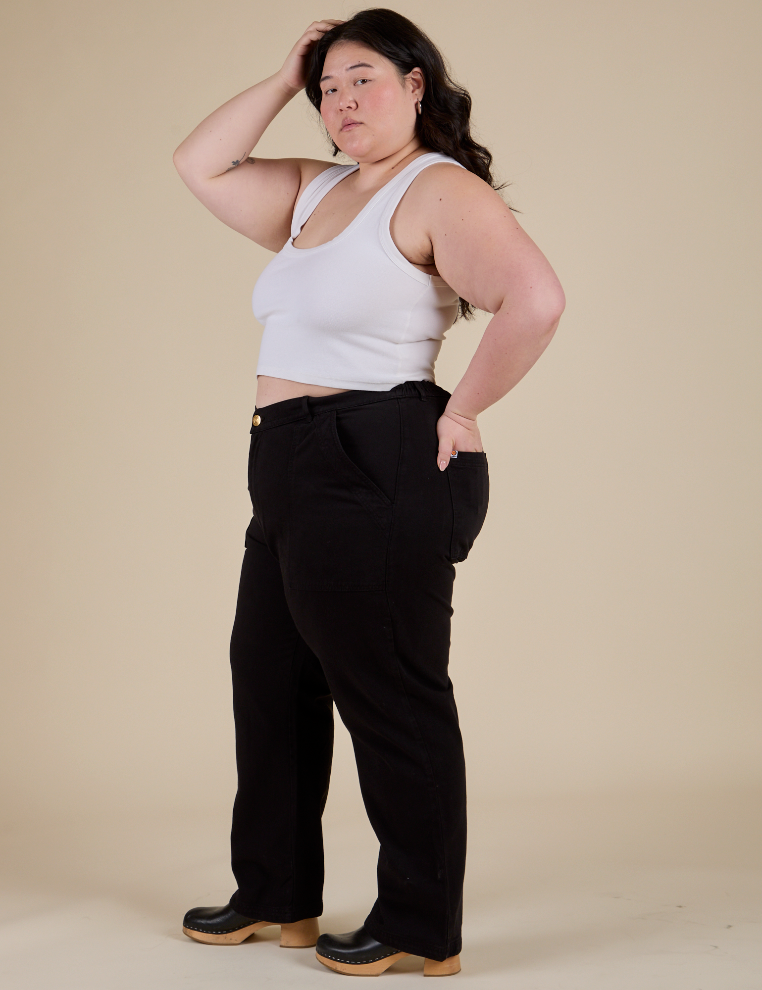 Side view of Work Pants in Basic Black and Cropped Tank in Vintage Tee White on Ashley