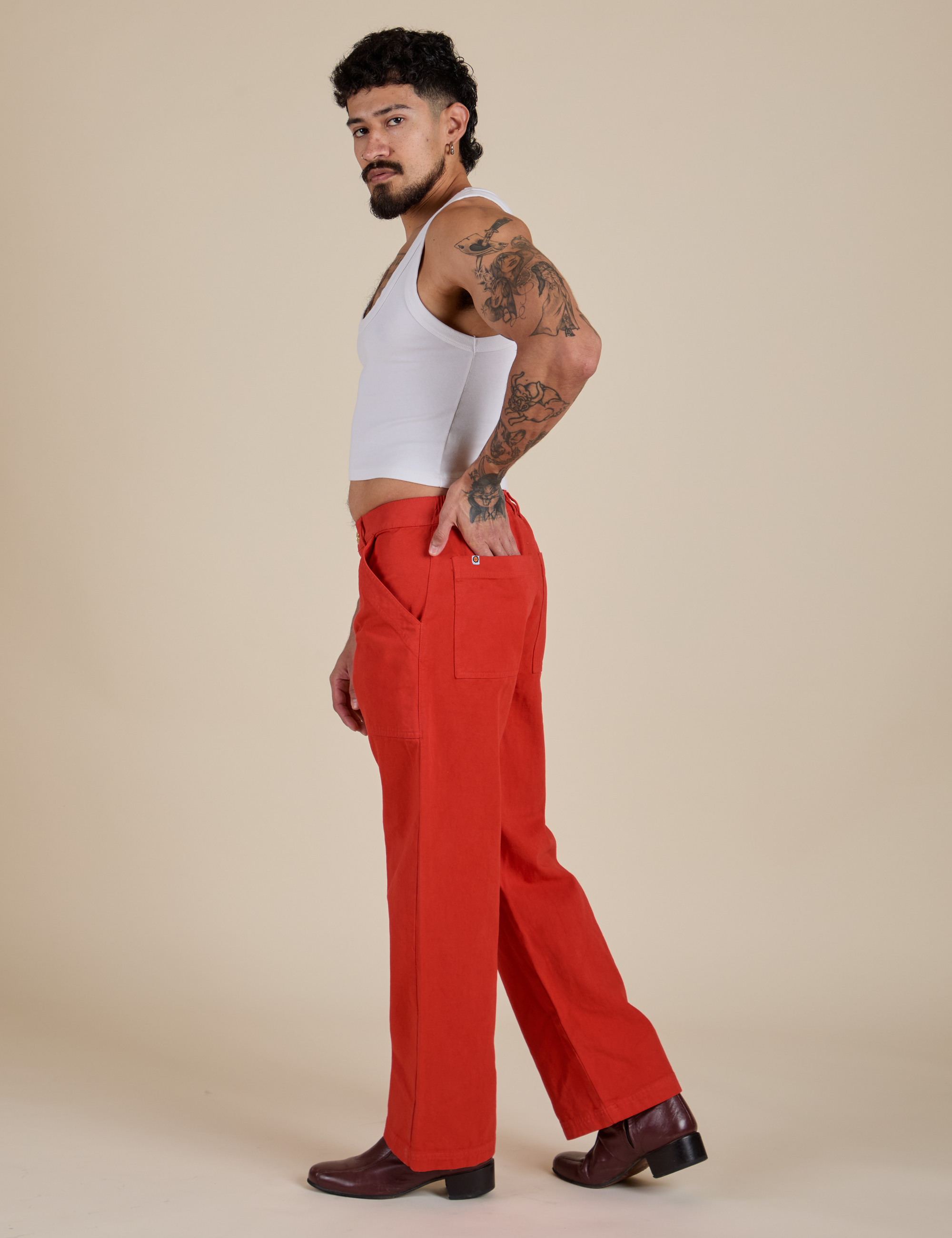 Side view of Work Pants in Mustang Red and Cropped Tank in Vintage Tee White on Jesse