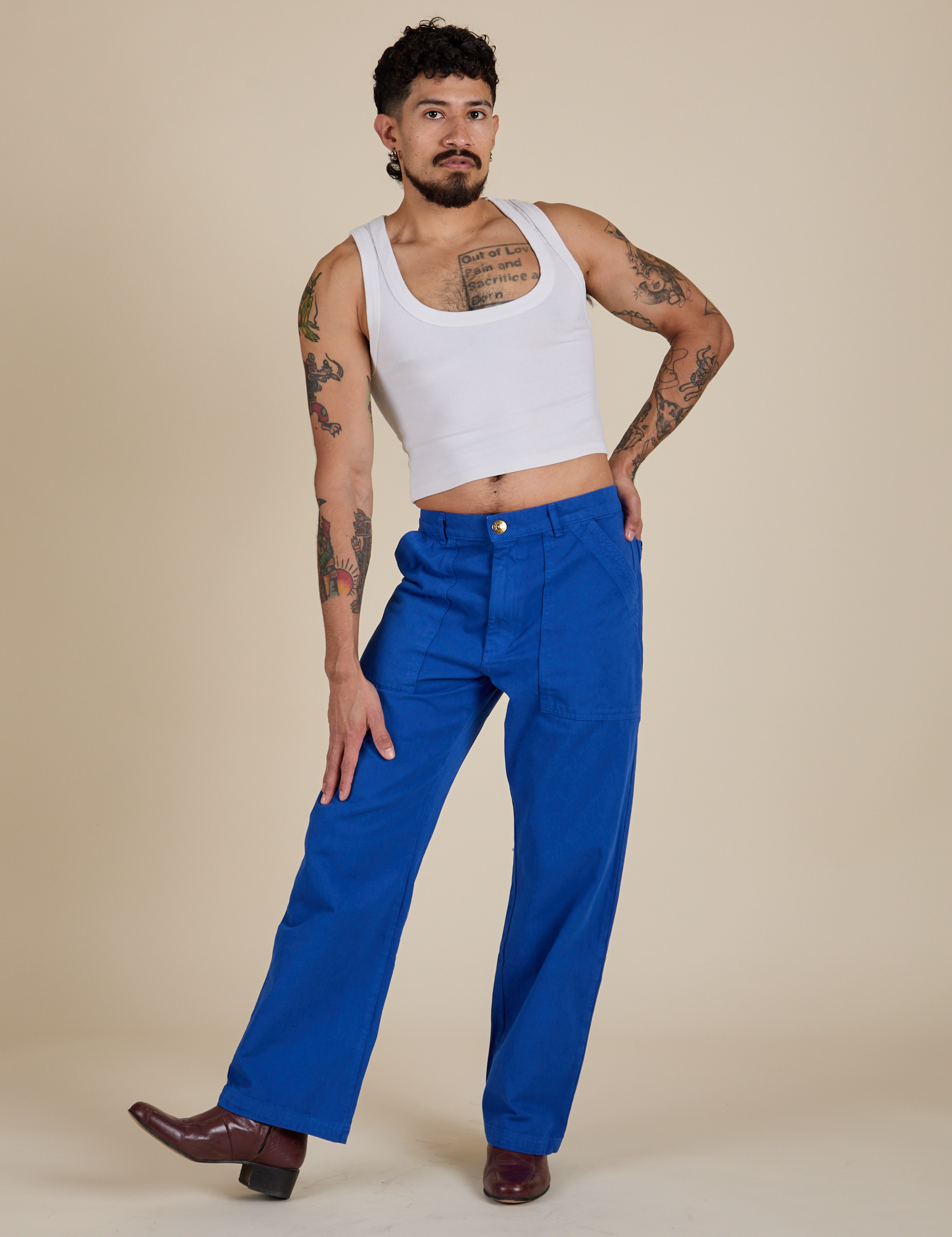 Jesse is wearing Work Pants in Royal Blue and Cropped Tank in Vintage Tee White
