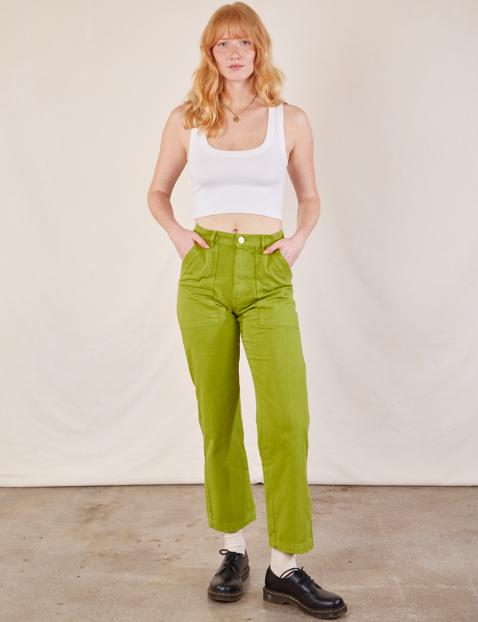 Margaret is wearing Work Pants in Gross Green and Cropped Tank in vintage tee off-white