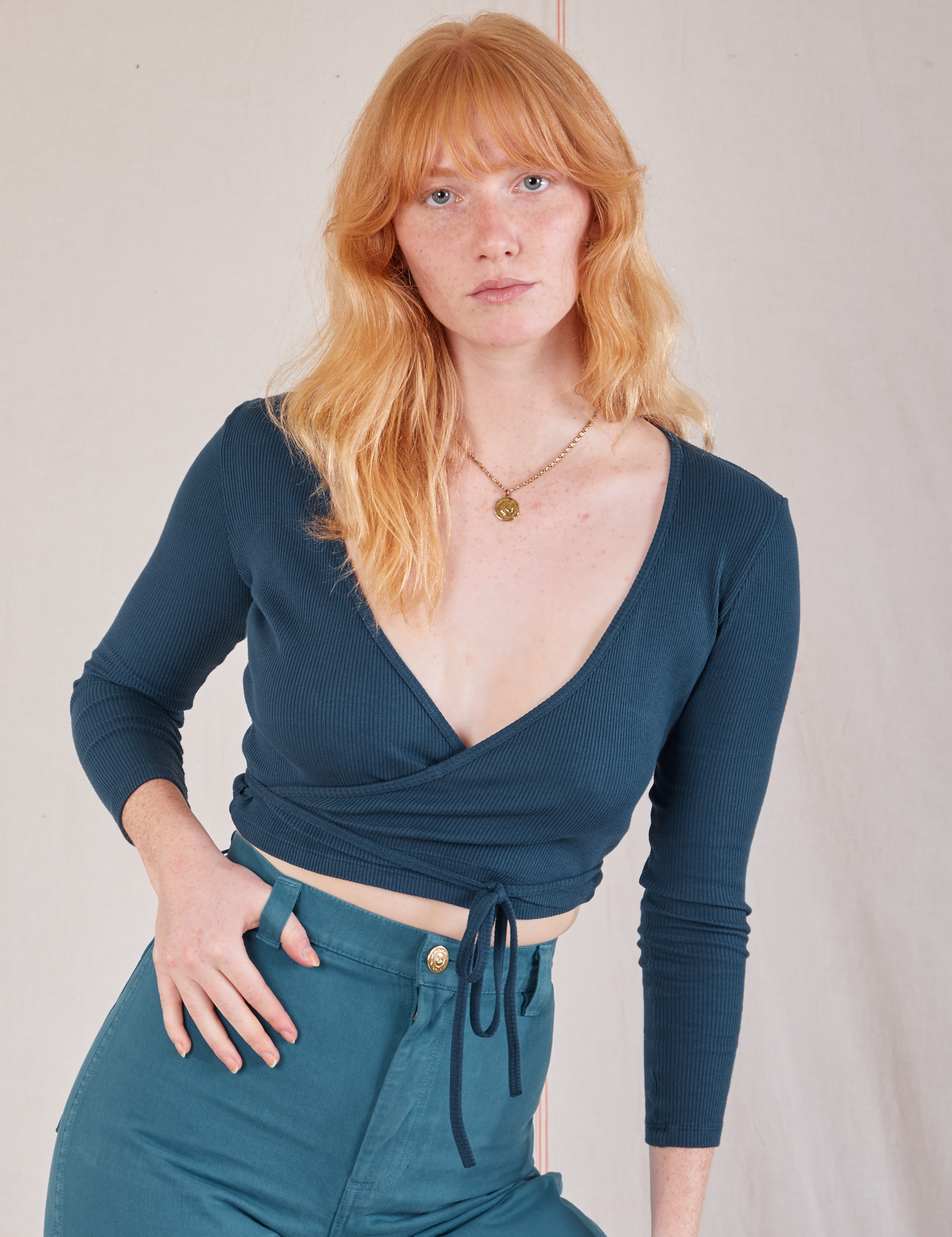 Margaret is wearing Wrap Top in Lagoon