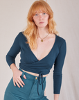 Margaret is wearing Wrap Top in Lagoon