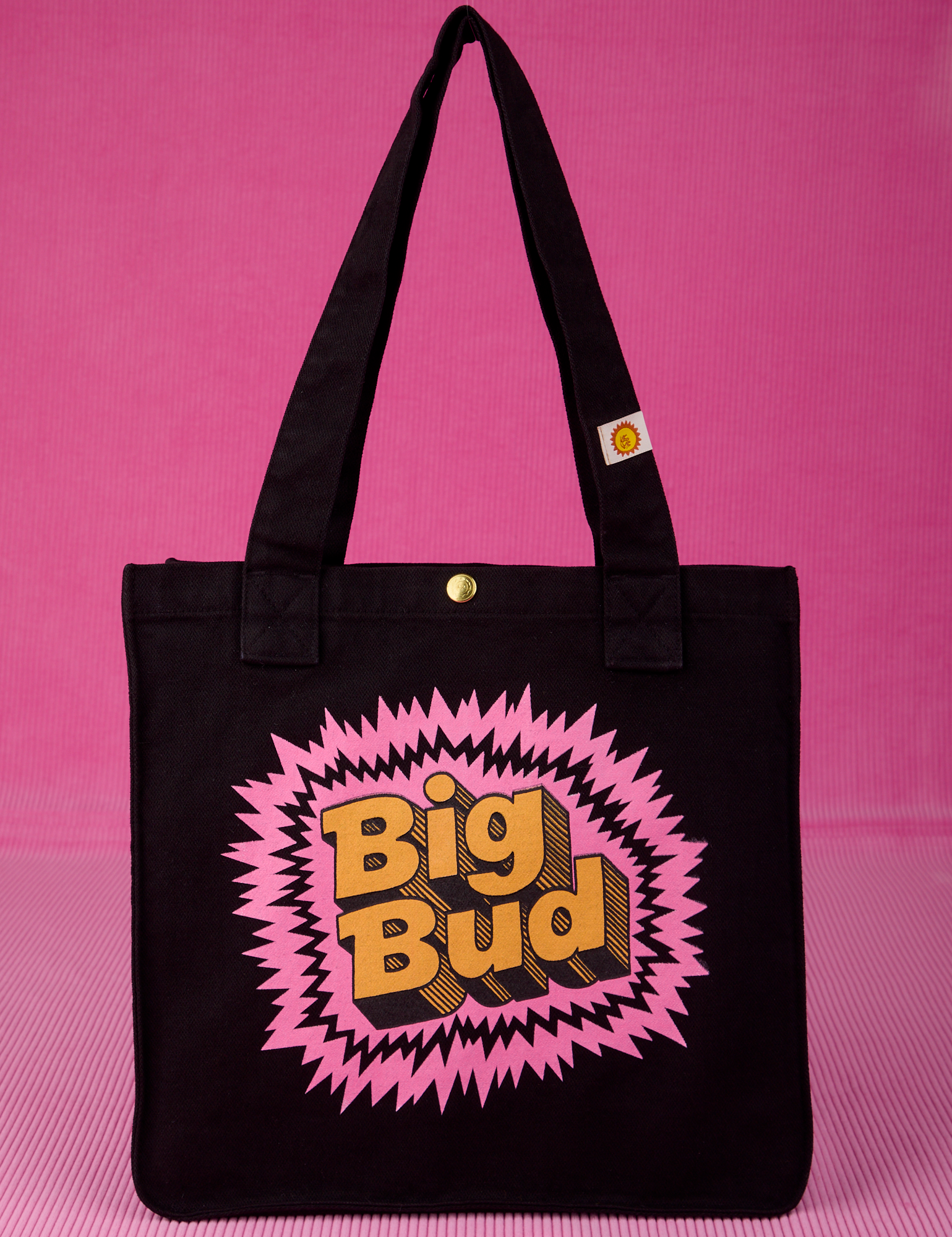 Bodega Shopper Tote in Explosion. Black bag body with screenprint bubblegum explosion shape and Big Bud in yellow text.