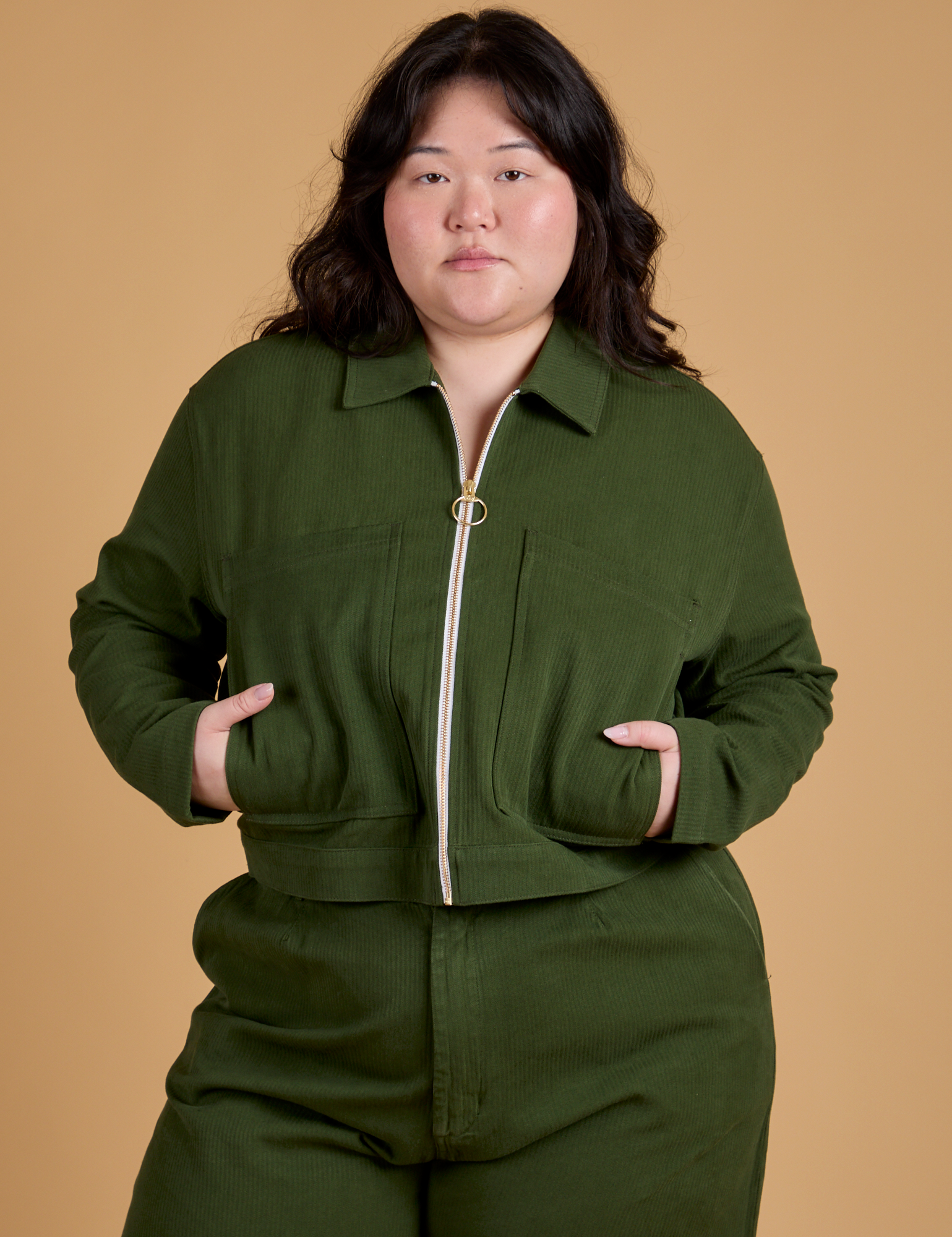 Ashley is wearing a zipped up Heritage Mechanic Jacket in Evergreen