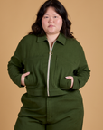 Ashley is wearing a zipped up Heritage Mechanic Jacket in Evergreen